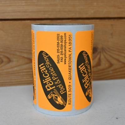 A roll of orange rectangular stickers for 'Pelican Pool & Patio Shop'