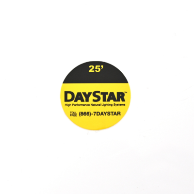 A circular sticker that is half yellow half black that reads 'DayStar'