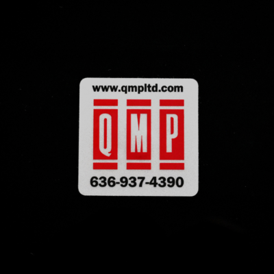 A reflective rectangular sticker with red and black details on it for 'QMP'