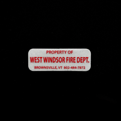 A skinny reflective sticker with red text that reads 'Property of West Windsor Fire Dept.'