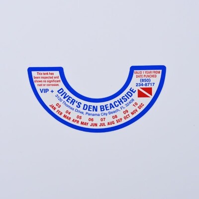 A half donut shaped sticker that is white blue and red text for 'Diver's Den Beachside'