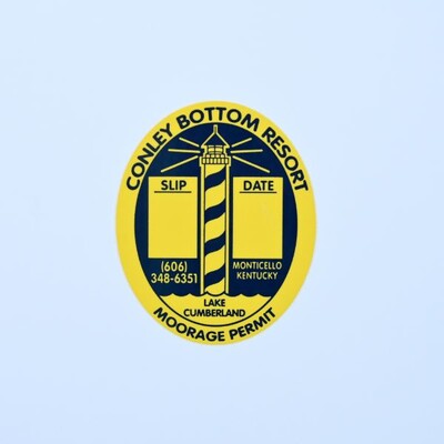 An oval sticker that is yellow and blue with a lighthouse design on it that reads 'Conley Bottom Resort'
