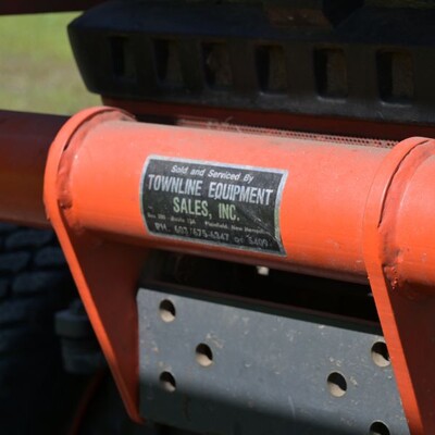 A black and silver rectangular sticker that marks a piece of equipment as belonging to the company 'Townline Equipment'