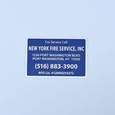 A rectangular sticker that is blue with white text that's the contact information for the New York Fire Service INC. 