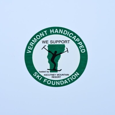 A circular sticker that is white with a thick green border for Vermont's Handicapped Ski Foundation
