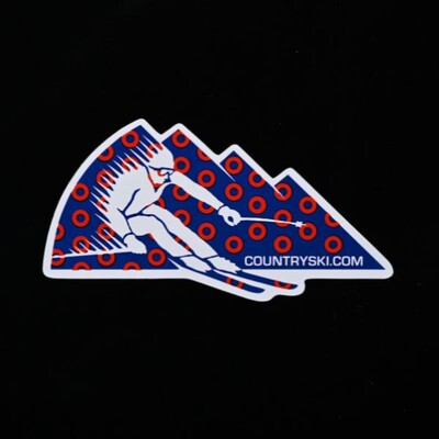 A Die Cut sticker of a skier going down a mountain that says 'countryski.com'