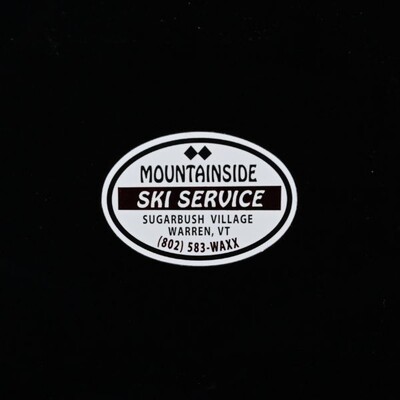 An oval sticker that white with a black design that reads 'Mountainside Ski Service'