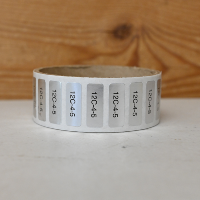 A roll of small silver ID sticker tags
